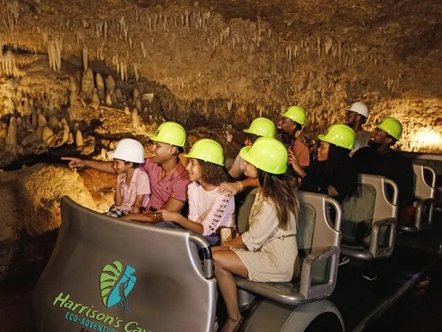 Group of tourists on a tram enjoying the Harrison's Cave tour.